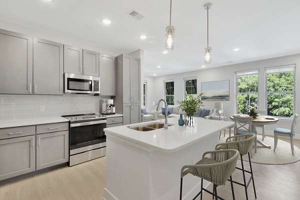 Modern kitchen with stainless steel appliances in Aquatera Apartments, luxury living redefined by Greystar in a vibrant community setting