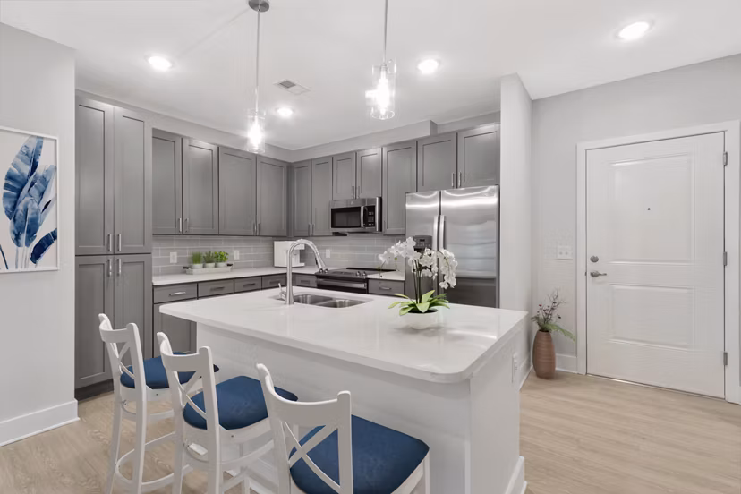 Modern kitchen with stainless steel appliances in Aquatera Apartments