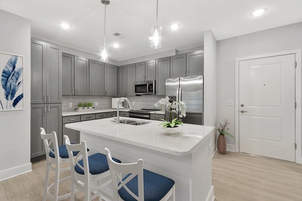 Modern kitchen with stainless steel appliances in Aquatera Apartments