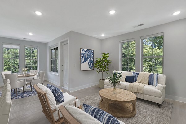 Stylish living room with modern decor and large windows in Aquatera Apartments, a luxury property managed by Greystar
