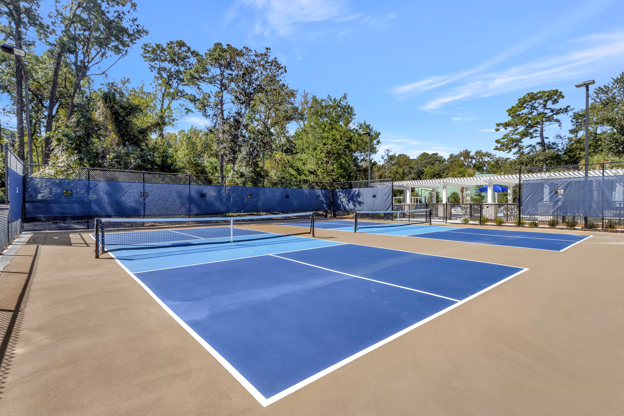 Sport court featuring basketball hoops at Aquatera Apartments, luxury apartments by Greystar