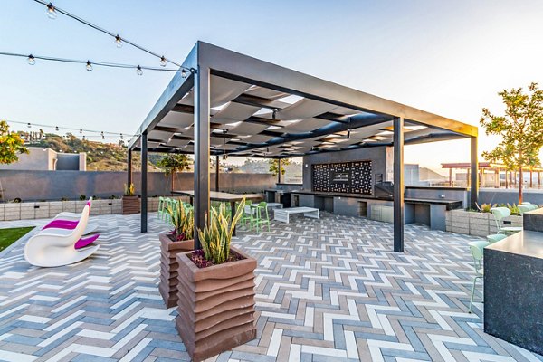 Outdoor grill area with modern patio furniture at Gravity Apartments