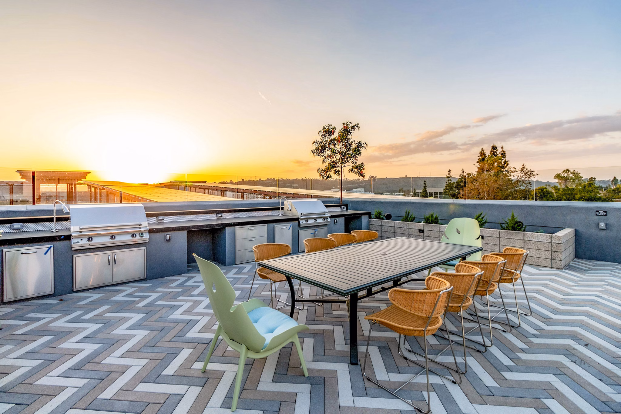 Grill area with modern patio seating at Gravity Apartments