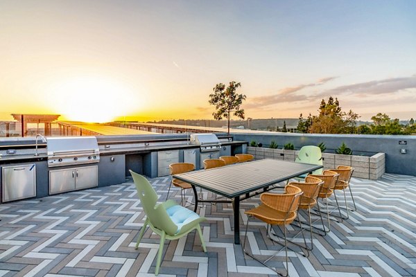 Grill area with modern patio seating at Gravity Apartments