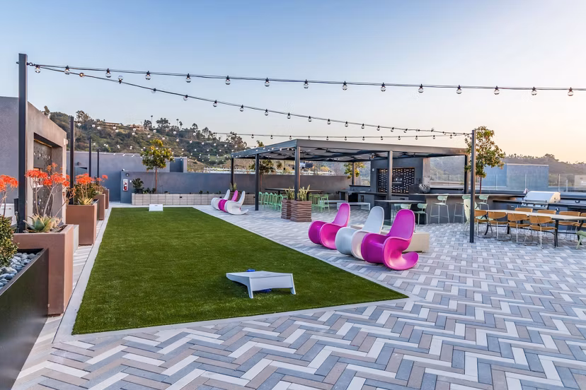 Recreational area with modern seating and game tables at Gravity Apartments, a luxury living community