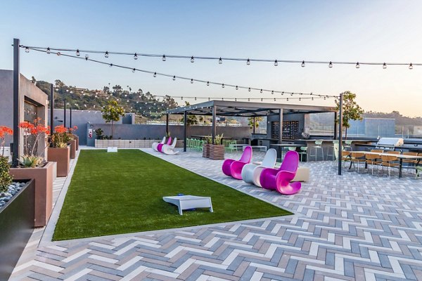 Recreational area with modern seating and game tables at Gravity Apartments, a luxury living community