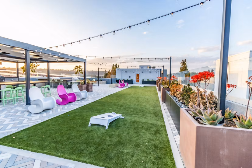 Modern recreational area with lounge seating and gaming stations at Gravity Apartments, perfect for relaxation and socializing