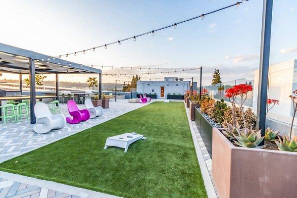 Modern recreational area with lounge seating and gaming stations at Gravity Apartments, perfect for relaxation and socializing