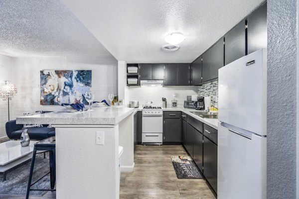 Modern kitchen with sleek cabinetry and island at Crosstown Phoenix West Apartments