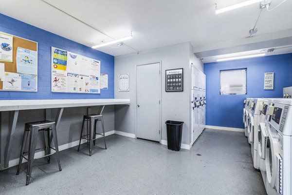 Laundry room with high-efficiency washers and dryers at Crosstown Phoenix West Apartments