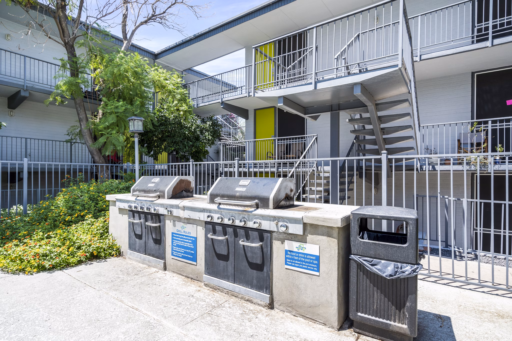 Spacious grill area with modern patio furnishings at Crosstown Phoenix West Apartments