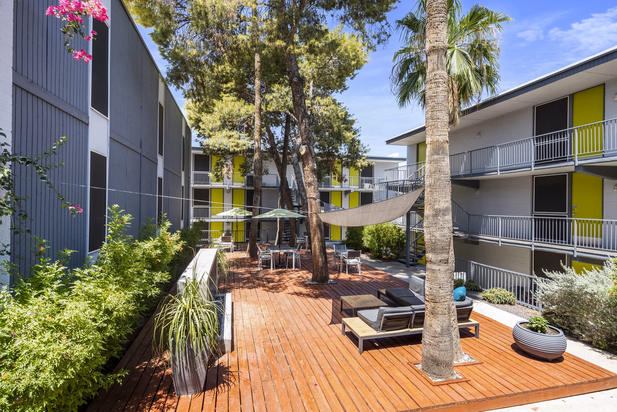 Patio with modern seating and garden views at Crosstown Phoenix West Apartments