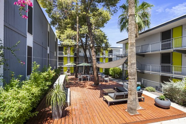 Patio with modern seating and garden views at Crosstown Phoenix West Apartments