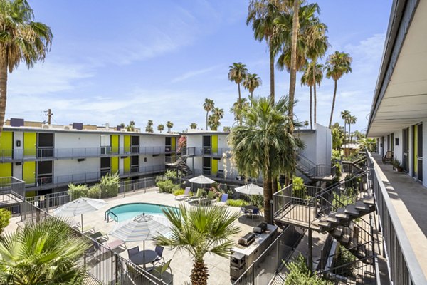Resort-style pool with loungers at Crosstown Phoenix West Apartments, offering luxury amenities and leisure spaces