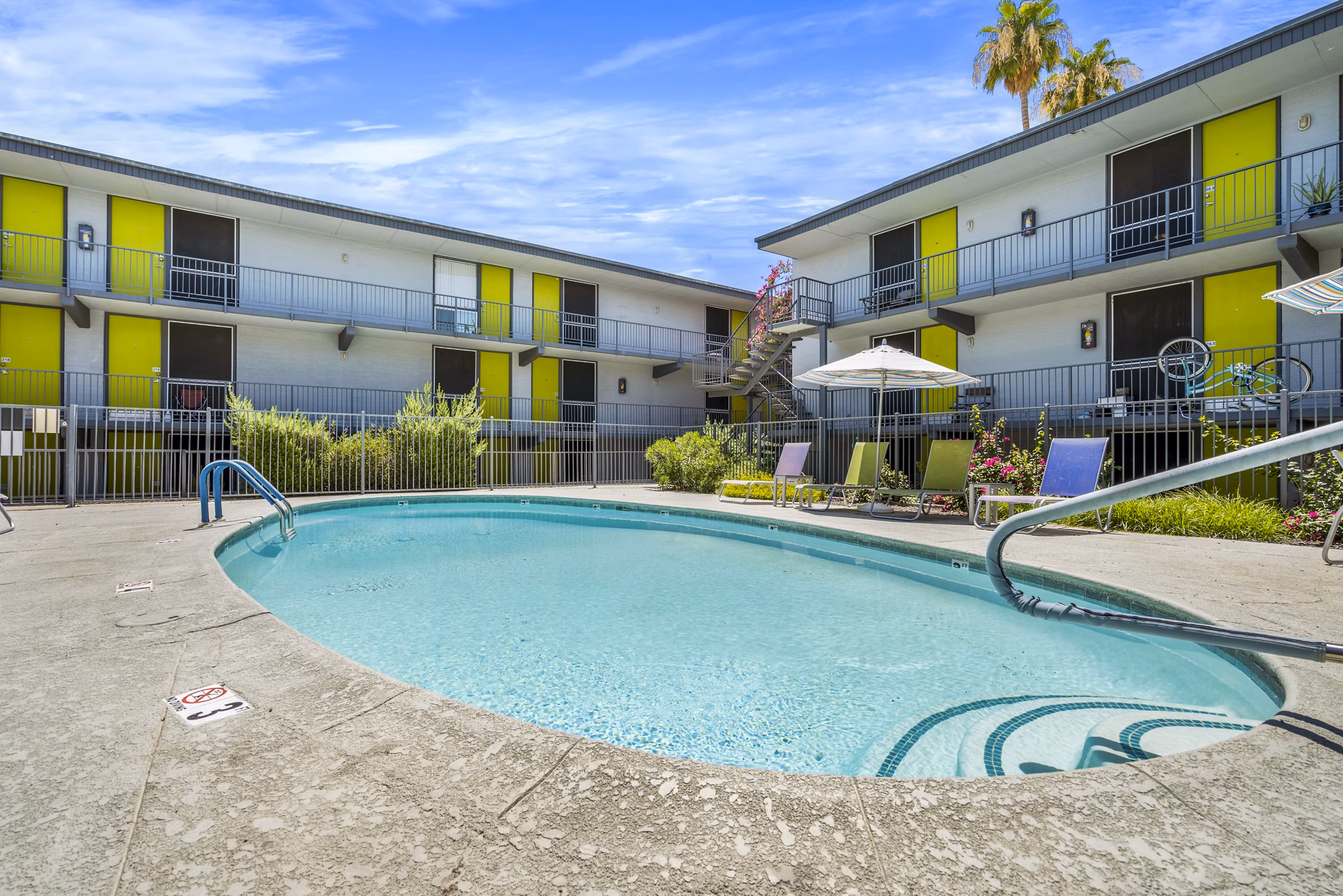 Olympic-sized pool with cabanas at Crosstown Phoenix West Apartments offering luxurious swimming experience