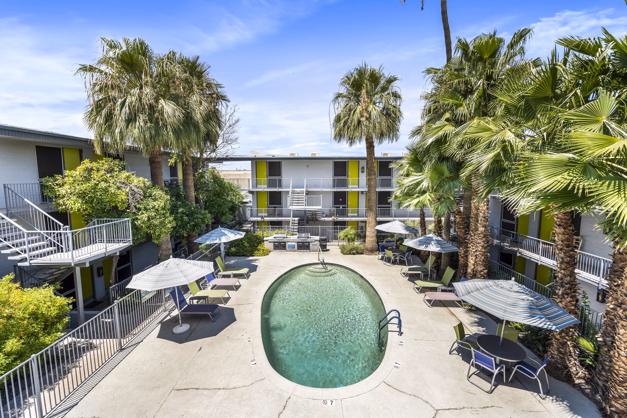 Crosstown Phoenix West Apartments: Luxury pool with sun deck and lounge chairs for relaxation