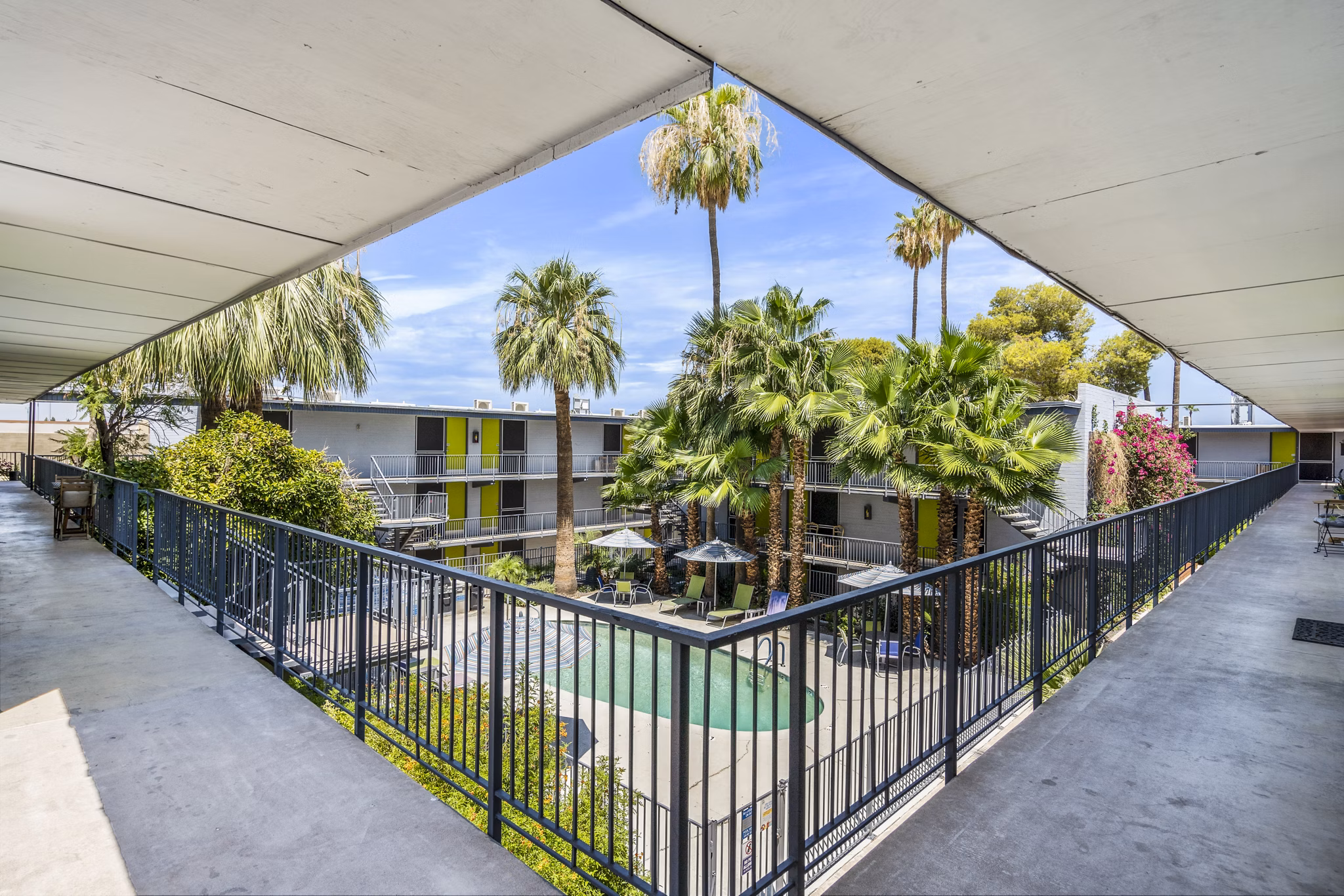 Inviting swimming pool area with lounge chairs at Crosstown Phoenix West Apartments