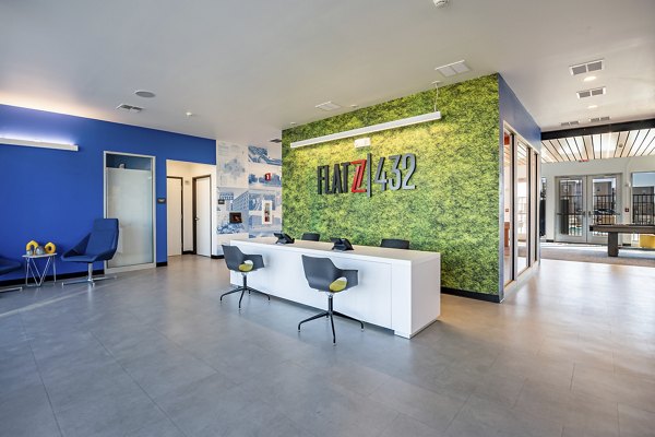 Modern clubhouse featuring communal seating areas and a coffee bar at FLATZ 432 Apartments, offering a stylish amenity space for social gatherings and relaxation