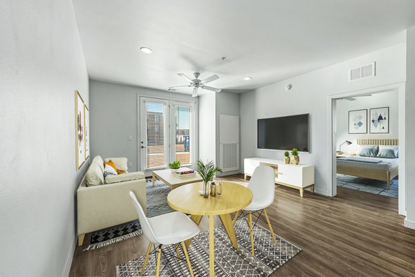 Dining room with modern lighting and sleek furniture at FLATZ 432 Apartments, a luxury property by Greystar