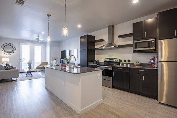 Modern kitchen with stainless steel appliances at FLATZ 432 Apartments