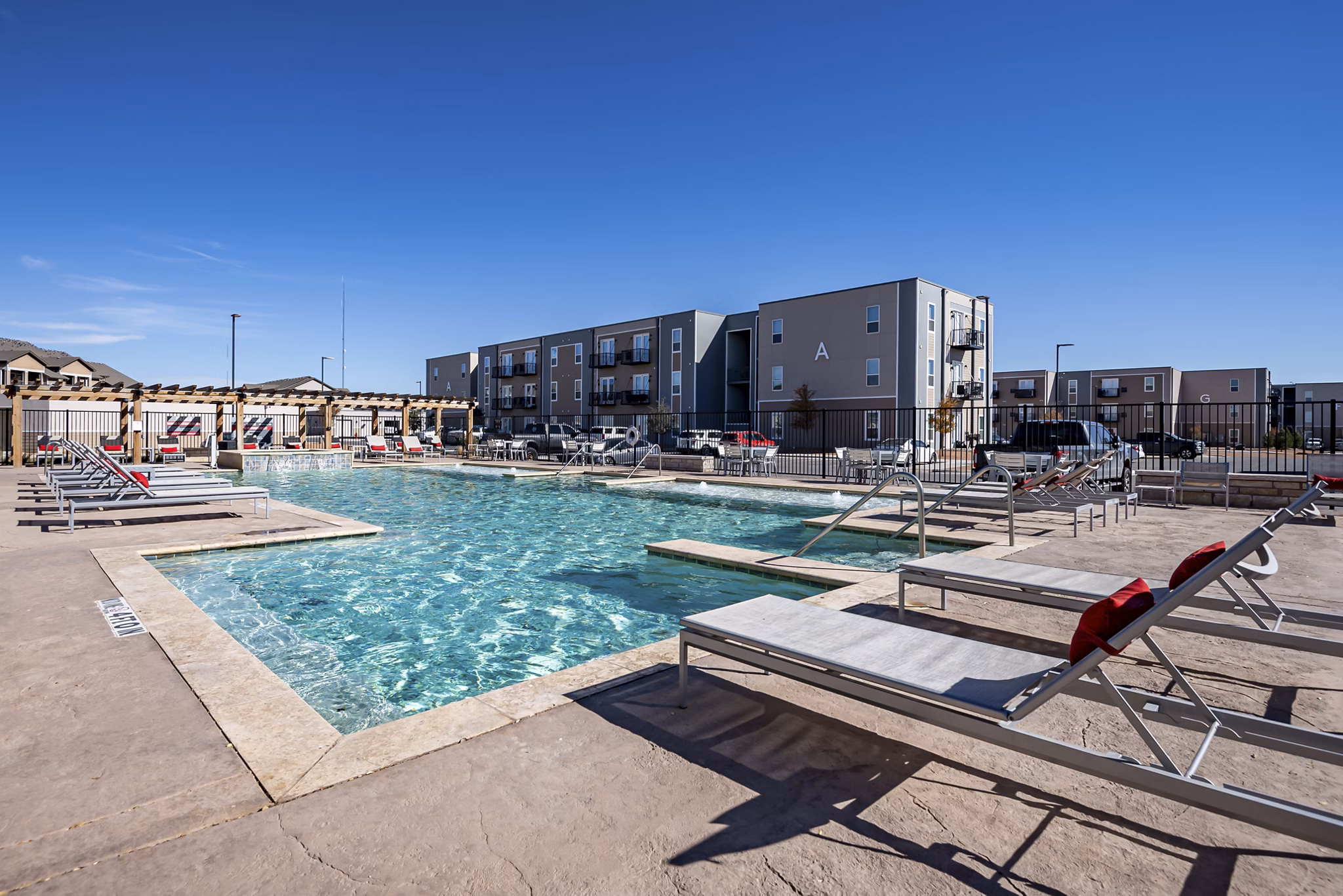 Modern pool area with lounge chairs at FLATZ 432 Apartments offering luxury living in an urban setting