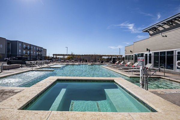 Rooftop pool with lounge chairs at FLATZ 432 Apartments, offering luxury relaxation in the city