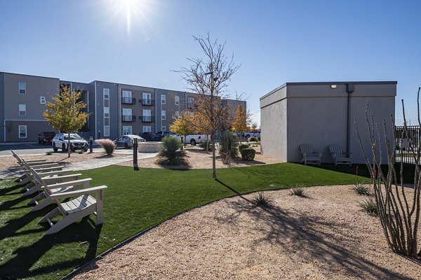 Courtyard with lush greenery and seating at FLATZ 432 Apartments