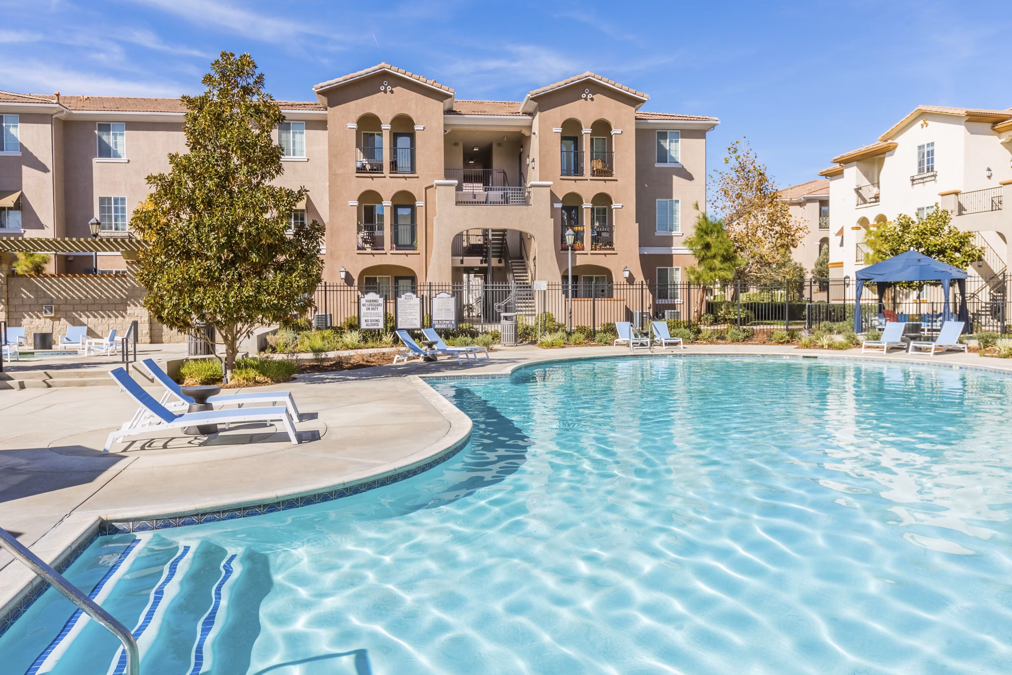 Resort-style pool at Viano at Riverwalk Apartments offering luxury relaxation amenities