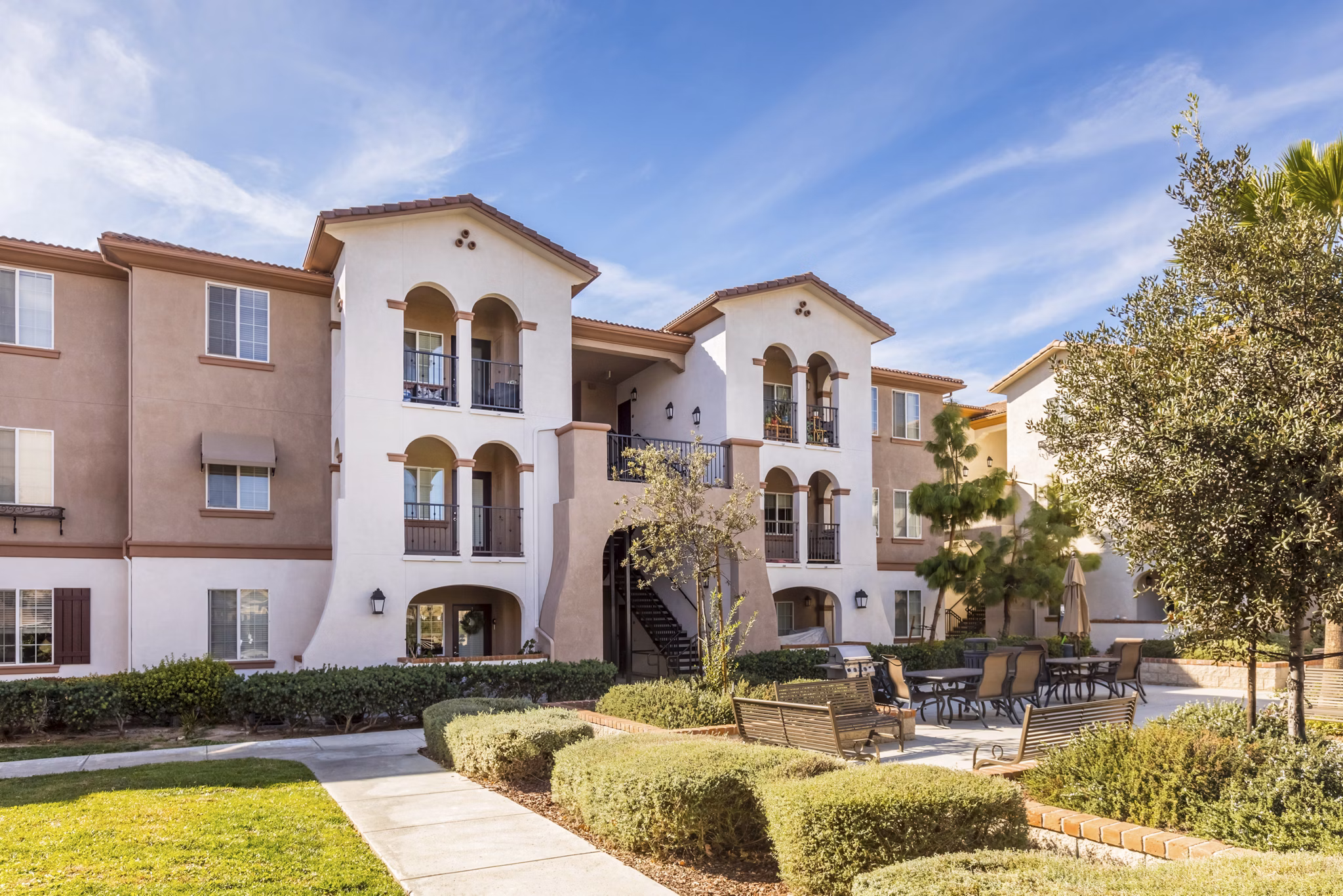 Courtyard featuring lush gardens and seating areas at Viano at Riverwalk luxury apartments