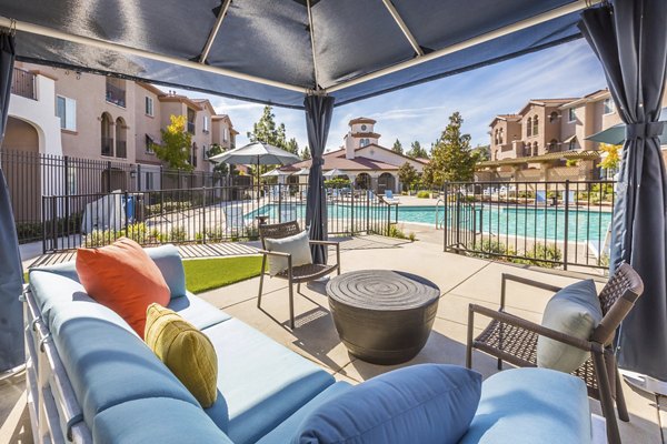 Inviting patio with modern furniture at Viano at Riverwalk Apartments, perfect for outdoor relaxation and social gatherings