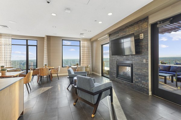 Vela on The Park: Elegant clubhouse with modern furnishings and communal seating areas in luxury apartment community