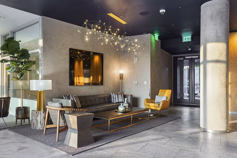 Elegant clubhouse featuring modern decor and ample seating at Vela on The Park Apartments