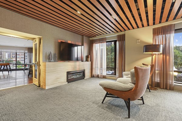 Clubhouse featuring modern design and ample seating at Vela on The Park Apartments