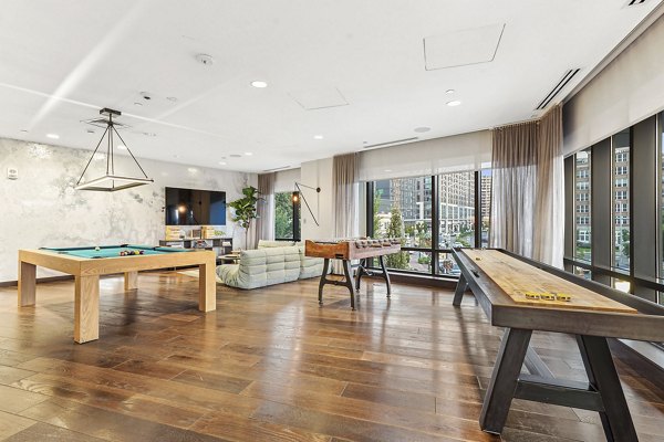 Clubhouse game room with billiards and large-screen TV at Vela on The Park Apartments, StamfordÑ€ÐµÐ½ÐµÑÑpoints for social and leisure activities