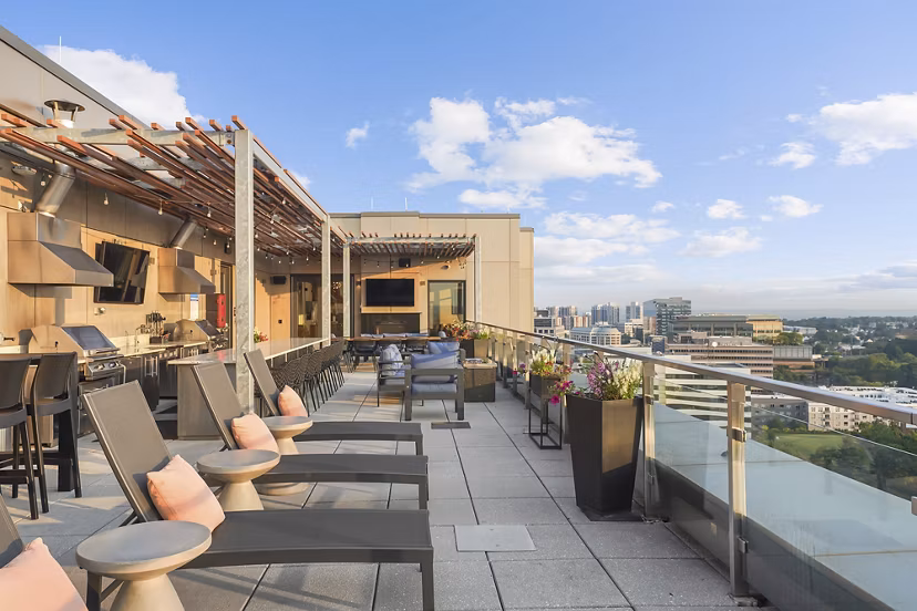 Spacious balcony with modern outdoor seating at Vela on The Park Apartments