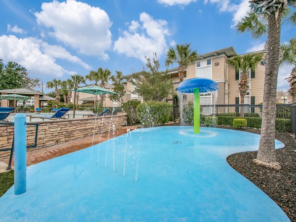 Relaxing poolside area with sun loungers at Westmount at Mason Creek Apartments