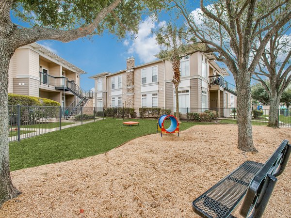 Outdoor recreation area with lush greenery at Westmount at Mason Creek Apartments, ideal for leisure and sports activities