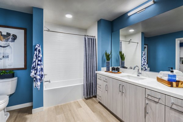 Cora Apartments: Modern bathroom with sleek fixtures and ample lighting