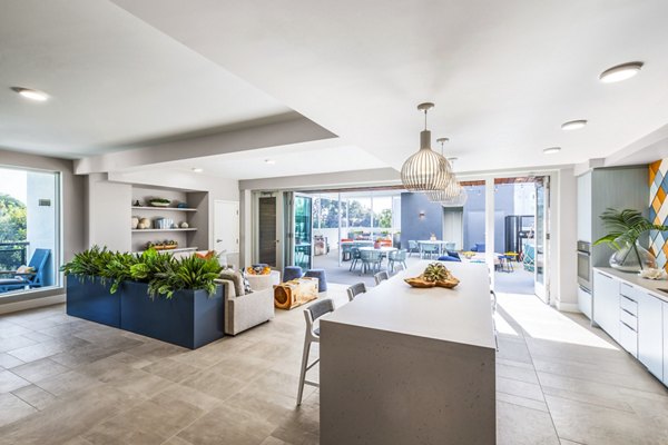 Cora Apartments: Stylish clubhouse featuring modern seating and lighting options in luxury community