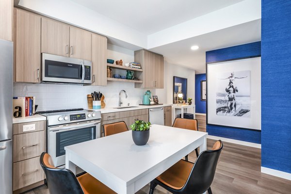 Dining room featuring elegant furnishings and modern lighting at Cora Apartments