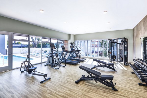 Fitness center with modern equipment at Cora Apartments for an active lifestyle