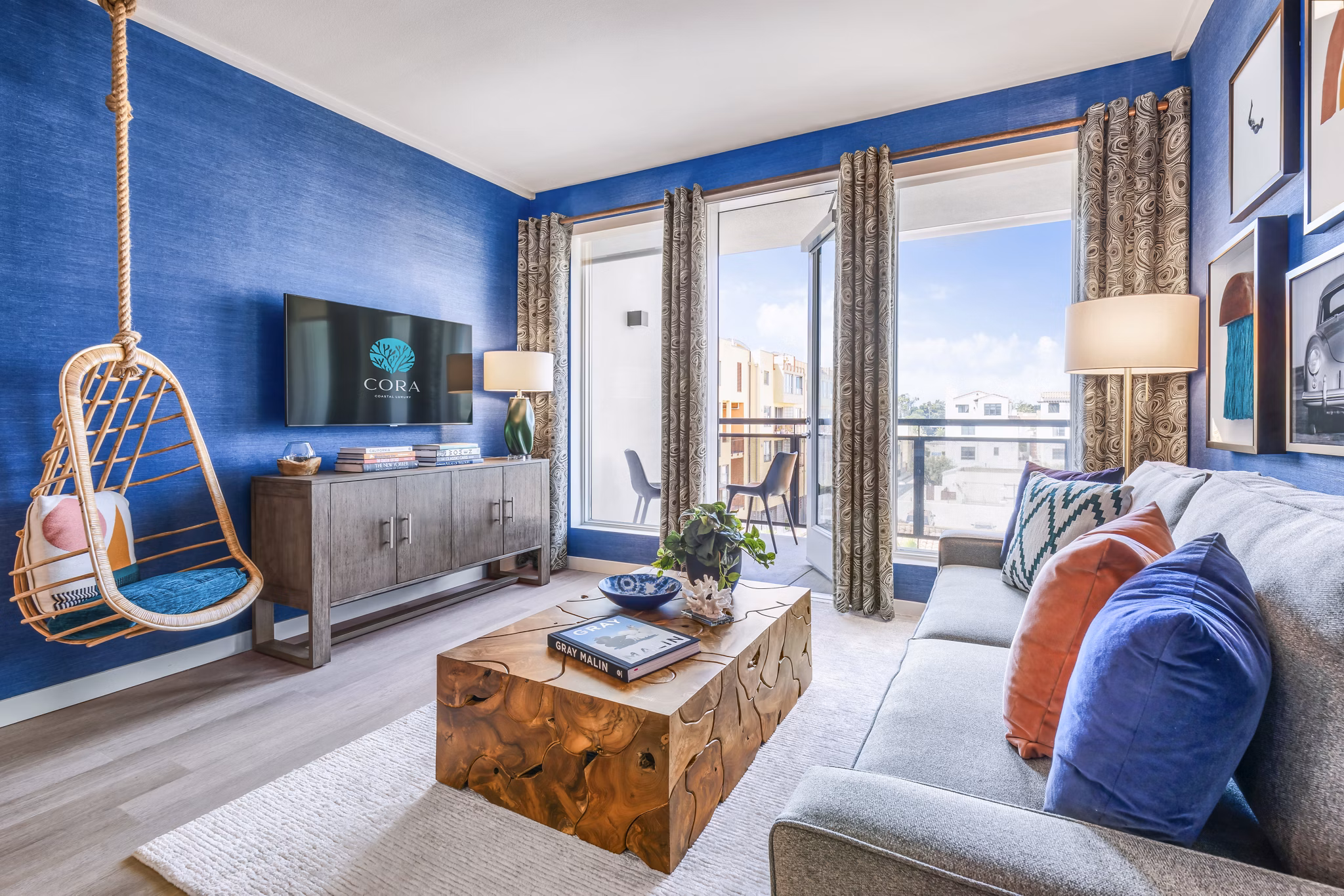 Elegant living room with stylish decor at Cora Apartments, featuring plush seating and abundant natural light