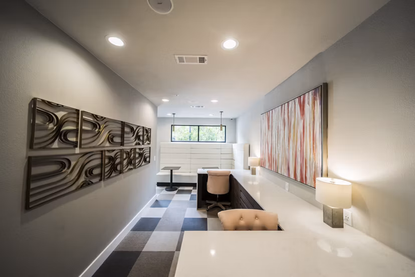 Clubhouse featuring modern design and cozy seating at Muse at SoCo Apartments in Austin Ideal for meetings and social gatherings