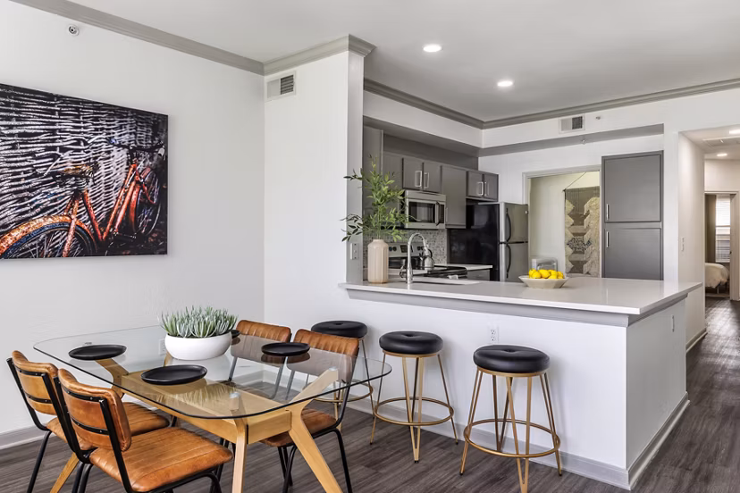 Dining room with modern decor and large windows at Muse at SoCo Apartments, offering a luxury living experience in the heart of the city