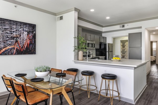 Dining room with modern decor and large windows at Muse at SoCo Apartments, offering a luxury living experience in the heart of the city