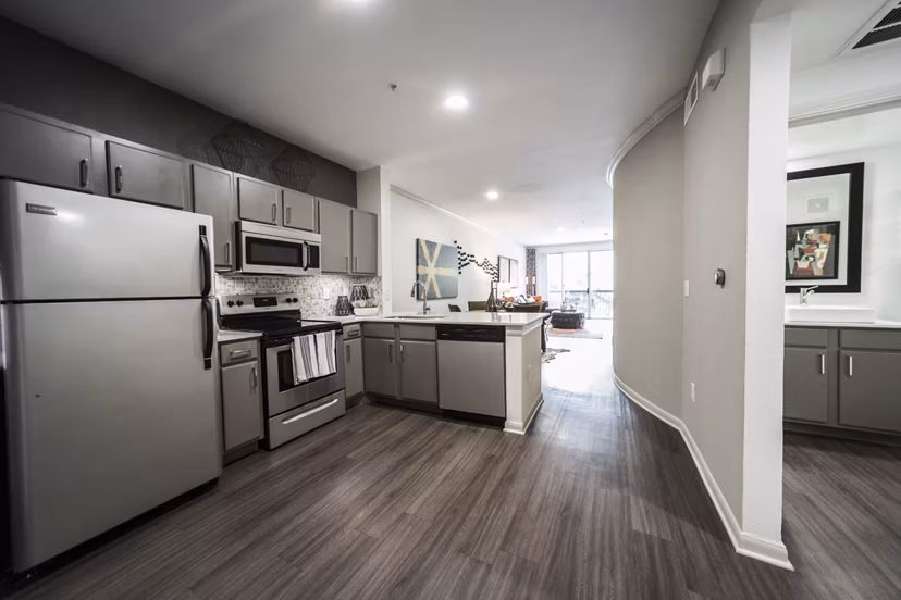 Modern kitchen with stainless steel appliances in Muse at SoCo Apartments Ideal for luxury living in a stylish Greystar community