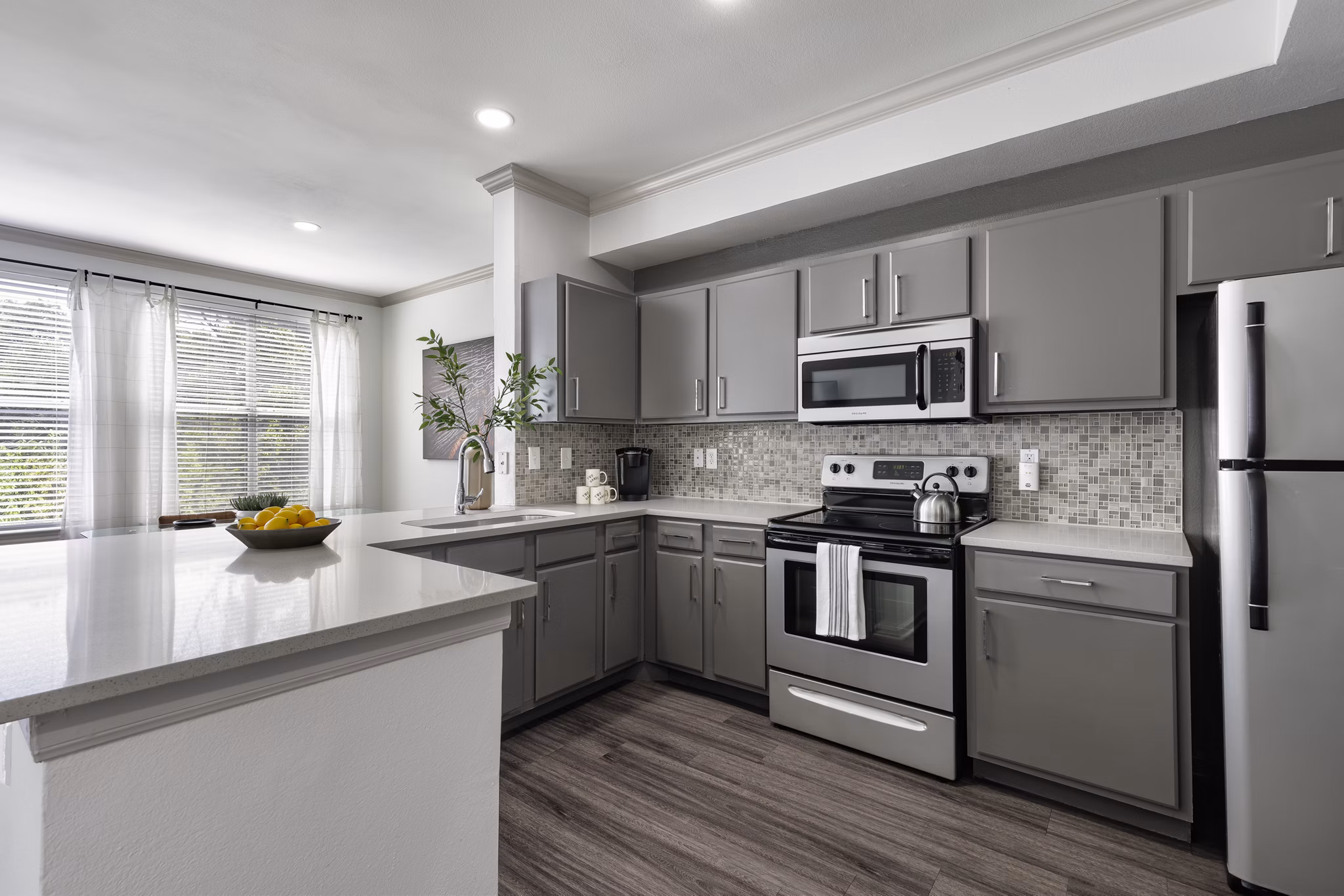 Kitchens with granite countertops and modern appliances at Muse at SoCo Apartments, luxury living by Greystar