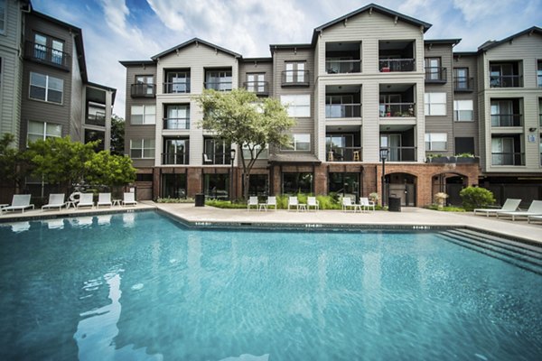Inviting outdoor pool with lounge chairs at Muse at SoCo Apartments, a luxury Greystar community in the heart of vibrant Austin