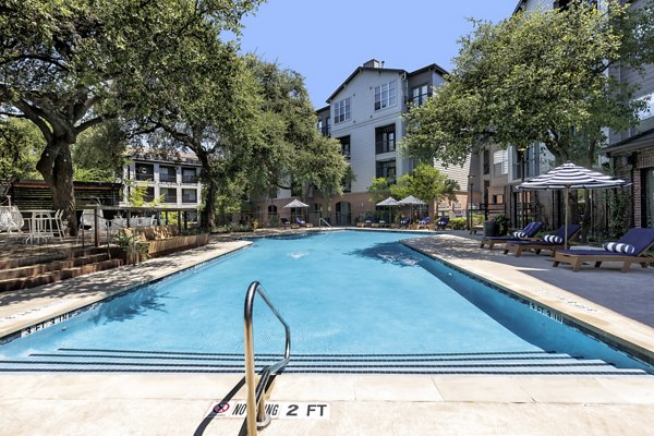 Modern pool with lounge chairs at Muse at SoCo Apartments