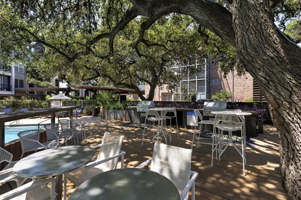 Outdoor grill area with modern seating at Muse at SoCo Apartments